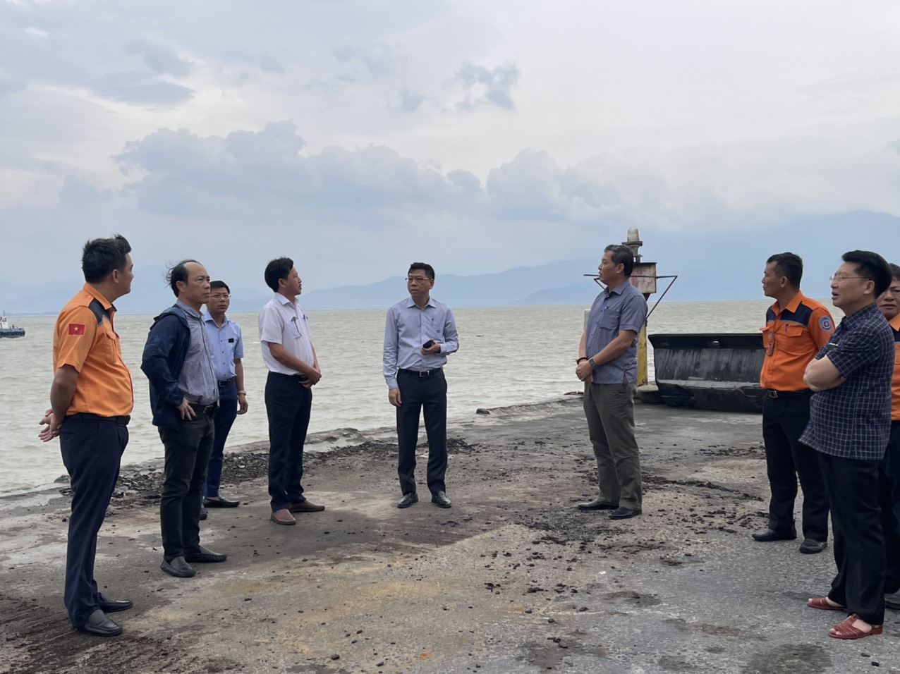 A group of people standing on a beachDescription automatically generated with low confidence